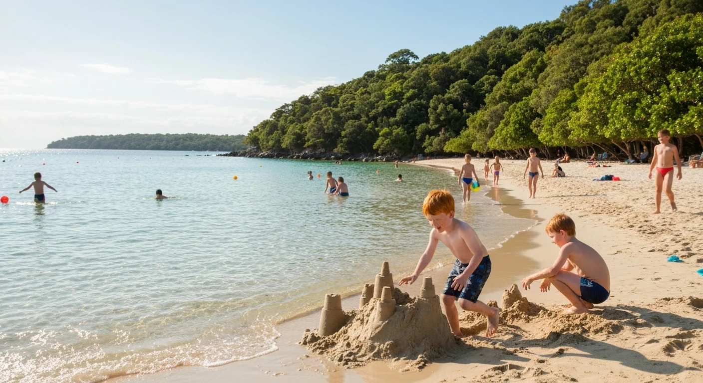 Children playing on sunny beach building sandcastles and splashing