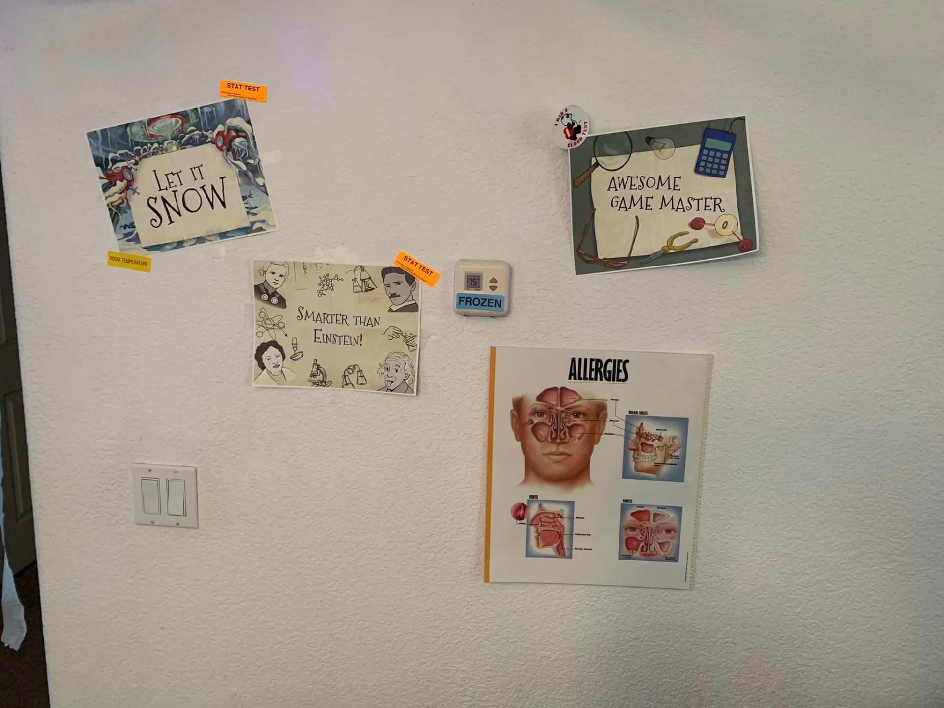 Des affiches du jeu du laboratoire du professeur Swen sont accrochées au mur.